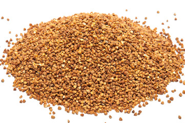 Heap of buckwheat grains on white background, close up view.