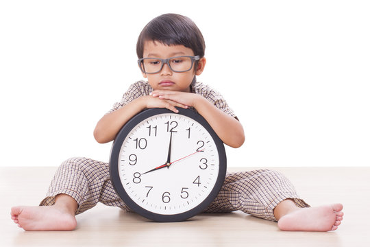 Cute boy is holding big clock 