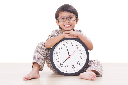 Cute boy is holding big clock 