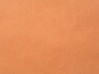 The paper with vertical line texture on orange color