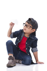 Happy boy playing with paper airplane 