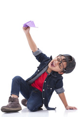 Happy boy playing with paper airplane 