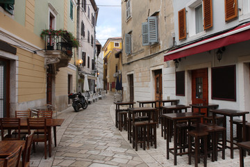 Old town street with restaurants  in Porec  in Croatia