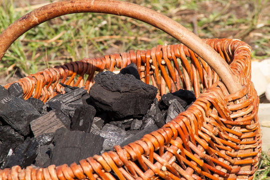 charcoal lying in a wicker basket on
