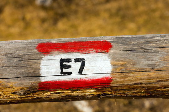 European Trail Sign E7 on a Wooden Pole / European Trail Sign E7 (Lisbon Portugal - Constance Lake Romania) on a wooden pole