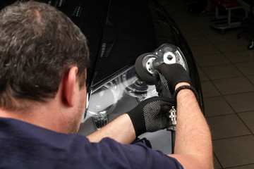 Car service. Polishing optics of the car