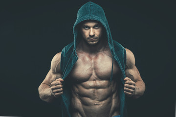Fototapeta na wymiar Man with muscular torso. Strong Athletic Men Fitness Model Torso showing six pack abs