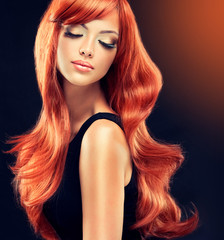 Fototapety  Piękny model dziewczyna z długimi rudymi włosami kręconymi. Fryzura i kosmetyki