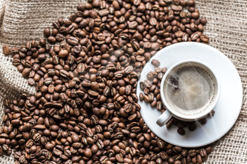 Coffee grains and coffee cup