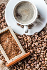 Coffee grains and coffee cup