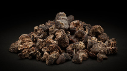 Pile of Organic Dried gooseberry or Amla (Ribes grossularia) on dark background.