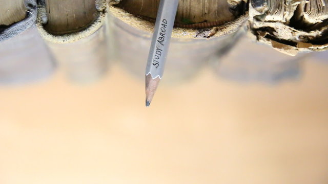 text: Study Abroad, pencil, and old books