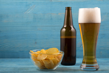 Beer and chips on a blue background
