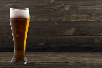 Glass of beer on a wooden countertop