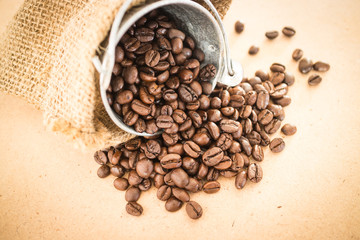 Coffee roasted bean in the bucket on wooden background