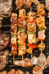 bbq meat with vegetables on stick fried on brazier