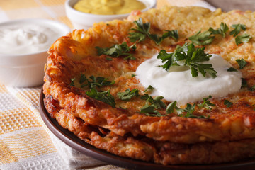 Swiss breakfast: potato flapjacks with sauce macro on a plate. horizontal
