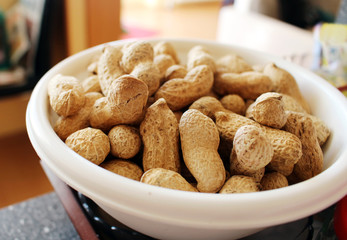 Detail of delicious peanuts in white bowl