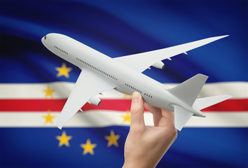 Airplane in hand with flag on background - Cabo Verde