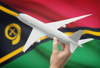 Airplane in hand with flag on background - Vanuatu