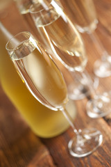 Glasses of champagne on wooden background
