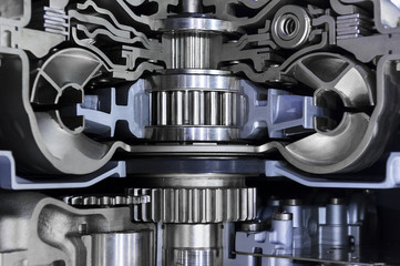 Gearbox cross-section, engine industry, sprockets, cogwheels and bearings of automotive transmission for oversize trucks, SUV, cargo, commercial and construction vehicles, selective focus 