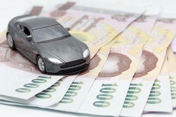 Toy car on money isolated on white background