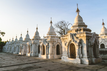 Fototapeta na wymiar White stupas at Kuthodaw Pagoda at Sunset in Mandalay, Myanmar