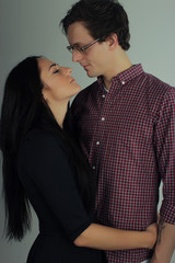 the young handsome man and the young attractive woman in the black embrace  kiss