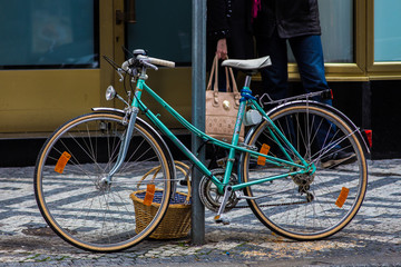Fototapeta na wymiar Bicycle parked on a street with food's basket.