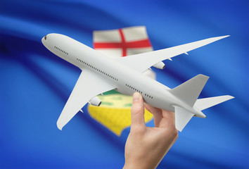 Airplane in hand with Canadian province flag on background - Alberta
