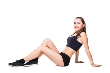 Fototapeta na wymiar Attractive fit woman exercising in studio with copyspace. Image of healthy young female athlete doing fitness workout against grey background.