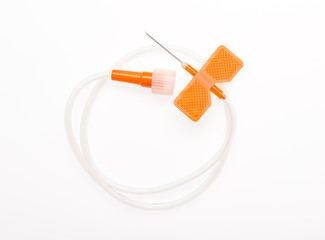 Orange butterfly catheter with open needle isolated on white background. Clipping path included.