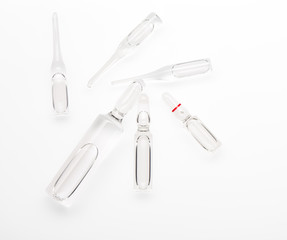 Six transparent white glass ampoules with a drug isolated on white background. Clipping path included.