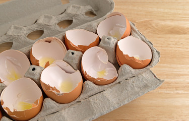 Broken eggshells in cardboard carton