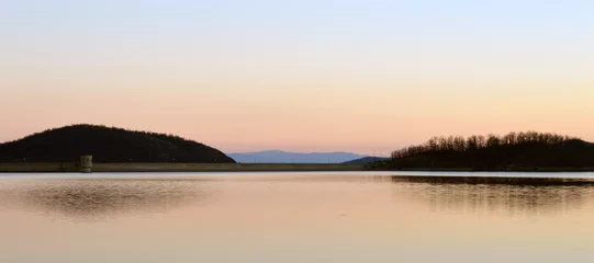 Foto op Canvas Artificial lake in sunset with reflection © Antanaskovic