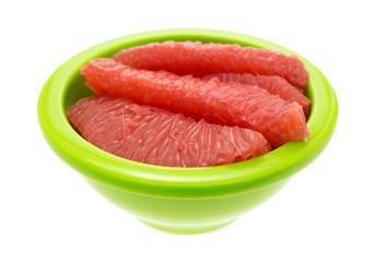 Red grapefruit sections in a green bowl