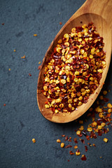 Chili flakes on a wooden spoon
