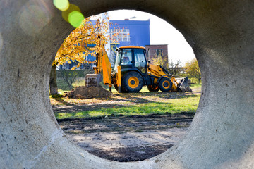 Excavator through the concrete tube