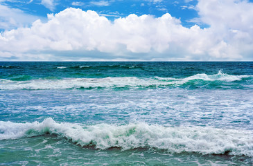 Big wave with sea foam and turquoise water.