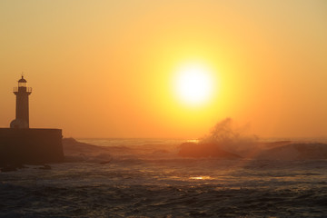 Lighthouse Felgueirasin Porto with wave splash at sunset