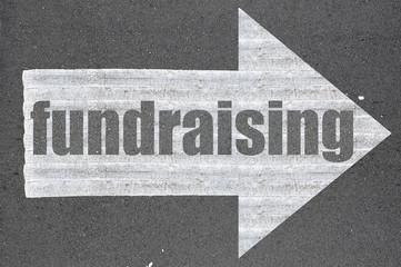 Arrow on asphalt road written word fundraising - 98919546