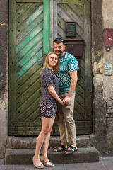 Couple in love near the door of an old house.