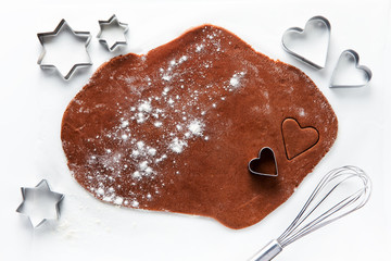 dough for chocolate cookies  and cookie cutters in the shape of
