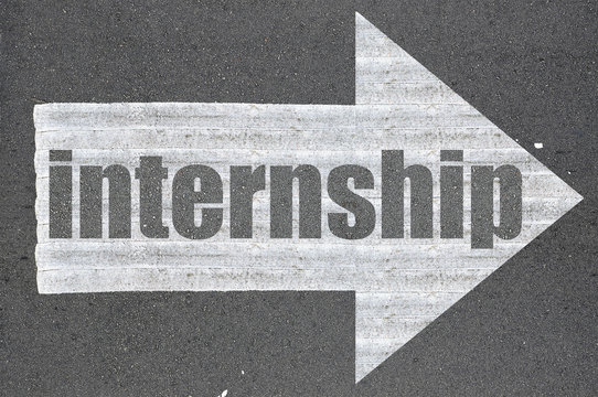 Arrow on asphalt road written word internship
