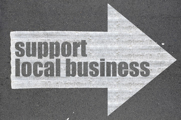 Arrow on asphalt road written word support local business - 98922936