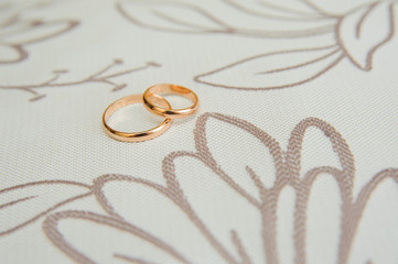 Wedding rings on floral design background