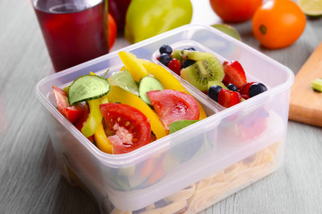 Tasty lunch in plastic containers on wooden table close up