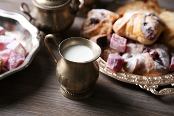 Antique tea-set with Turkish delight and baking on table close-up