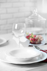 Table set at restaurant on light background